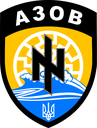 Shield-shaped emblem with a black symbol, blue waves, and the word AZOV in white text.