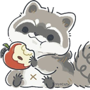 A small gray raccoon with a white face eating a red apple with a content expression.