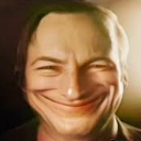 A man with a heavily distorted, unnaturally wide, and mischievous grin.