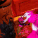 A bright pink creature with a white face hungrily biting into a dark, textured object in a pixel art style.