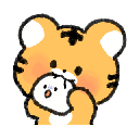 A cute orange tiger cub holding and biting into a small white dumpling.