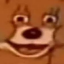 Cartoon character face with wide, staring eyes and a broad, unsettling grin in a low-resolution, distorted style.