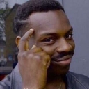 Man pointing to his temple with a smug, knowing smile.