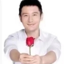 A man smiling while holding out a single red rose toward the viewer.