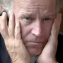 Man holding his face with both hands looking directly at the camera with a disappointed expression.