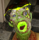 A grotesque zombie head with glowing neon green skin and wide eyes looking shocked.