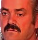 El Risitas laughing with a wide, toothy grin and squinted eyes.