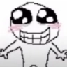 A crudely drawn character with massive wide eyes and a giant toothy grin, featuring pink blush marks on its cheeks.