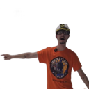 A man wearing a hard hat and orange t-shirt points emphatically to the side with an excited expression.