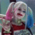 Harley Quinn with pink and blue pigtails giving an okay hand gesture with a mischievous grin.