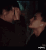 A couple sharing an intimate kiss in a sequence of frames.