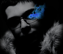 A person wearing glasses with a bright blue flame glowing from their eye in a dark setting.