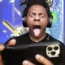 IShowSpeed with eyes wide open and tongue sticking out while holding a phone.