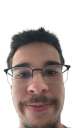 A man with glasses and a mustache wearing a smug, knowing smirk.