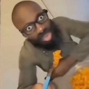 Man with glasses and a beard staring wide-eyed at the camera with a shocked expression.