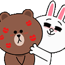 A white rabbit kissing a brown bear, leaving multiple red lipstick marks on the bear's face.