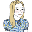 A blonde girl with a gentle expression wearing a blue floral dress.