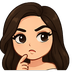 Girl with brown hair touching her chin while looking thoughtful.