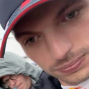 Max Verstappen wearing a cap looking into the camera with a smug expression.