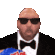 A bald man in a black tuxedo and sunglasses repeatedly reaches into a blue bag to eat chips.