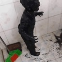 Gerbert standing in a tiled bathroom looking dark and mysterious.