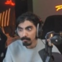 Man wearing headphones with a wide-eyed, confused expression.