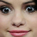 Selena Gomez looking directly at the camera with wide, suspicious eyes and a slight smirk.