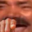 A close-up of a man pointing his finger at the camera while laughing.