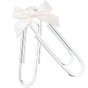 A silver paperclip decorated with a small white ribbon bow.