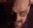 Walter White making a stern, suspicious face while pointing his finger.