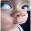 Baby face with extreme fisheye lens distortion looking confused and skeptical.