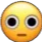Yellow smiley face with large dilated black pupils and a flat mouth staring forward.