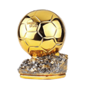 A golden soccer ball trophy sitting on a textured gray base.