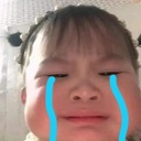A child with a filter showing bright blue cartoon tears streaming down their face.