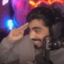 Man wearing headphones saluting with a smirk.