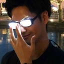 A man adjusting glasses that are glowing with intense white light.