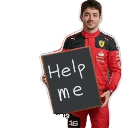 A race car driver in a red uniform holds a small chalkboard with the words help me written in white chalk.