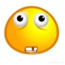 A yellow smiley face with wide eyes and two prominent front teeth staring blankly.