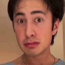 A person with wide, skeptical eyes looking directly at the camera with a judgmental expression.