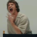 Man with a wide-open mouth and intense expression of shock or disbelief.