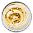 Hummus in a white bowl topped with chickpeas and olive oil.