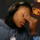 Person wearing headphones covering their eyes with their hand in a facepalm gesture.