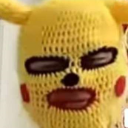 Yellow knitted balaclava mask with red circular cheeks and dark eye and mouth openings.