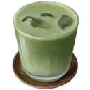 Iced matcha latte in a glass on a wooden coaster.