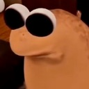Marcus the creature staring forward with extremely large, wide, unblinking eyes.