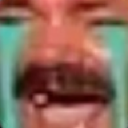 A close-up, pixelated face with a mustache laughing intensely with a wide, distorted grin.