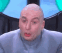 Dr. Evil from Austin Powers looking at the camera while holding his pinky finger to his lower lip.