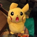Pikachu plush toy with hands on its cheeks and mouth wide open in a shocked expression.