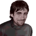 Fernando Alonso wearing a dark shirt with a smug, knowing smirk on his face.