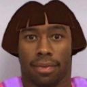 Tyler, the Creator with a photoshopped Dora the Explorer bob haircut looking directly at the camera.